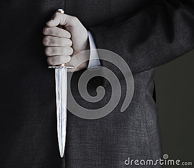 Midsection Of Businessman Holding Knife Stock Photo