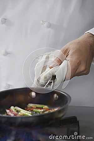 Midsection Of Chef Cooking Food Stock Photo