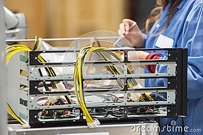 Midsection of female engineer repairing computer part in electronics industry Stock Photo