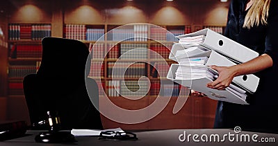 Midsection Of Female Lawyer Carrying Stack Of Ring Binders Stock Photo