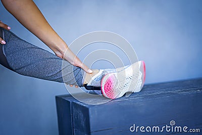 Midsection of female runner holding twisted ankle Stock Photo