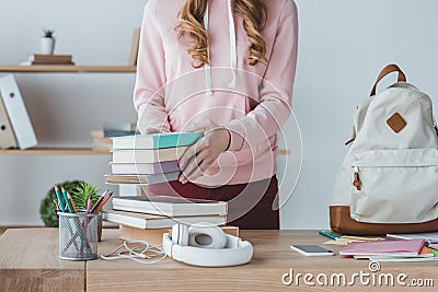 midsection view of female student with books and backpack Stock Photo