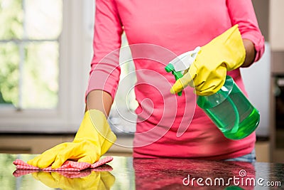 Midsection of woman cleaning the counter Stock Photo