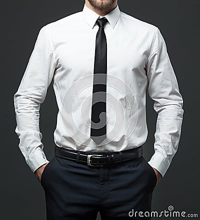 Midsection of young businessman in formal white shirt, black tie Stock Photo