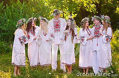 Midsummer. A group of young people of Slavic appearance at the celebration of Midsummer Stock Photo