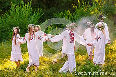 Midsummer. A group of young people of Slavic appearance at the celebration of Midsummer Stock Photo