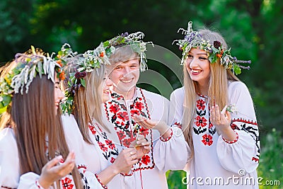 Midsummer. A group of young people of Slavic appearance at the celebration of Midsummer Stock Photo