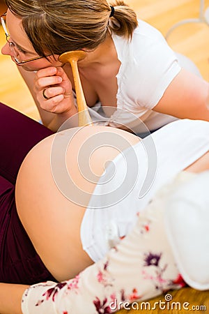 Midwife seeing mother for pregnancy examination Stock Photo