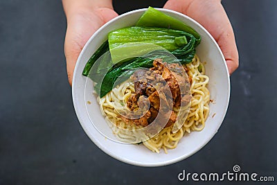mie ayam or noodles chicken is traditional food from indonesia, asia made from noodle, chicken, chicken broth, spinach, sometimes. Stock Photo