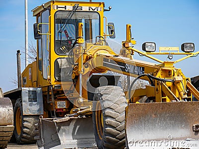 Bulldozer close up shot on local industrial park. Editorial Stock Photo