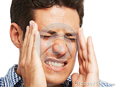 This migraine is unbearable. A young man holding his head as a result of a splitting headache. Stock Photo