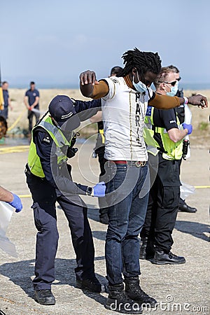 Migrants and asylum seekers are searched by police and border force officers before being processed. Editorial Stock Photo