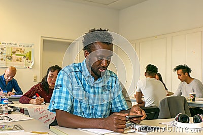 Migrants learn a language in a European school, at integration courses. Europe, Germany, Halle Saale, 05/12/2017 Editorial Stock Photo