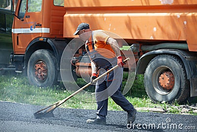 Installing new asphalt surface on a road Editorial Stock Photo