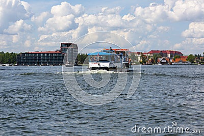 View from MikoÅ‚ajskie Lake of town, tourist ship, Mikolajki, Masuria, Poland Editorial Stock Photo