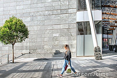 Milan, detail of Piazza Gae Aulenti, sunny day with young woman Editorial Stock Photo