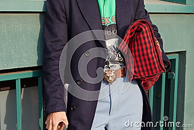 Man with Gucci belt with Tiger head and red and black checkered bag before Gucci fashion show, Milan Fashion Editorial Stock Photo