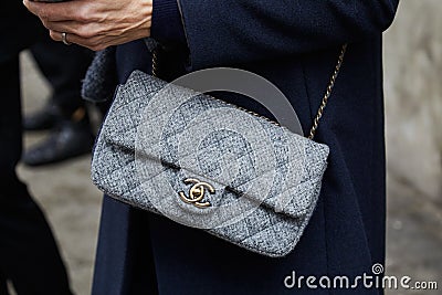 Woman with gray fabric Chanel bag with golden details before Max Mara fashion show, Milan Fashion Week street Editorial Stock Photo