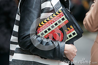 Woman poses for photographers with colorful bag with intricate design before Etro and Iceberg fashion show, Editorial Stock Photo