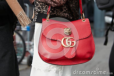 Woman poses for photographers with red Gucci bag with tiger head before Gucci fashion show, Milan Fashion Editorial Stock Photo