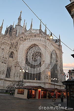 Backside of Duomo and kiosks of the Christmas market at Duomo early in the morning. Editorial Stock Photo