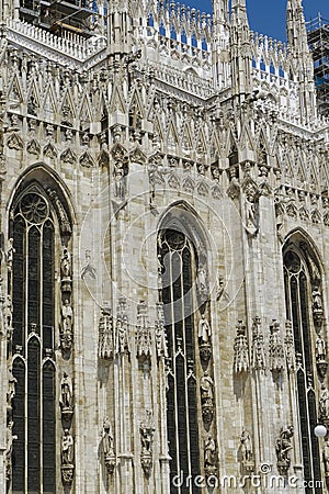 Milan, Italy Duomo architectural detail. Ornate features and artwork across the side view of Milano Roman Catholic Cathedral Stock Photo
