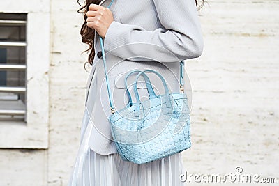 MILAN, ITALY - FEBRUARY 25, 2023: Woman with light blue leather bag, grey jacket and silver skirt before Missoni fashion show, Editorial Stock Photo