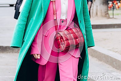 Milan, Italy - February, 24, 2022: woman wears leather red mini Bottega Veneta Cassette bag Editorial Stock Photo