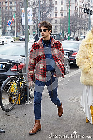 Man with red, beige and black checkered shirt and blue denim shirt before Gucci fashion show Editorial Stock Photo