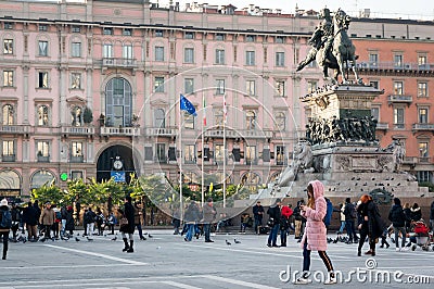 People relax on the main square of Milan - Piazza del Duomo near the monument to the first king of Italy Vittorio Emanuele II Editorial Stock Photo