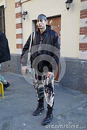 Top model with black bomber jacket and black and white trousers before Marni fashion show, Milan Editorial Stock Photo