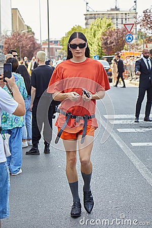 Man with orange shirt and shorts and black leather belt before Prada fashion show, Milan Editorial Stock Photo