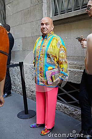 Man with pink trousers and yellow and blue silk short before Versace fashion show, Milan Fashion Editorial Stock Photo