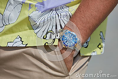 Man with Rolex Subariner watch with blue dial, gold and steel before MSGM fashion show, Milan Editorial Stock Photo