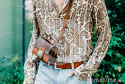 Milan, Italy - June, 19, 2022: man wears medium shoulder bag from the Crown Me collection and paisley printed shirt from Editorial Stock Photo