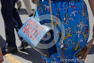 Woman with blue leather bag with writing `Monday is for heroes` before Etro fashion show, Milan Editorial Stock Photo