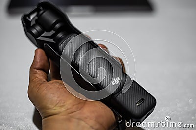 Milan, Italy 4.04. 2024: Male hand holding pocket camera stabilizer DJI Osmo Pocket 3 Editorial Stock Photo