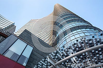 Milan, Italy, March 2020. Low angle view of a high-rise building with beautiful entrance decor. Glass roof with geometric shapes/ Editorial Stock Photo