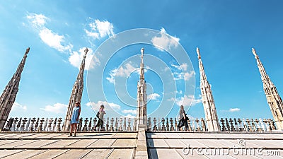 People visit the Milan Cathedral roof or Duomo di Milano. It is a top tourist attraction of Milan. Panoramic view of beautiful Editorial Stock Photo