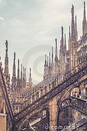 View of Milan Cathedral roof. People visit beautiful terrace. Milan Cathedral or Duomo di Milano is top tourist attraction of Editorial Stock Photo