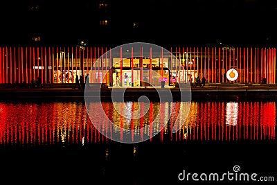 Milan, Italy - October 19th, 2015:High luminous red pillars with Vodafone logo on the waterfront Editorial Stock Photo