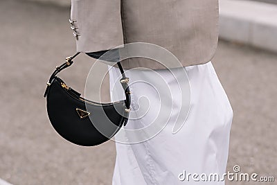 Milan, Italy - September 21, 2023: fashioner wearing Prada Arque black shoulder bag. Fashion blogger outfit details Editorial Stock Photo