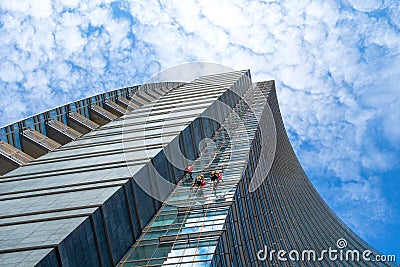 Group of Alpinists in service for windows cleaning of skyscraper Editorial Stock Photo