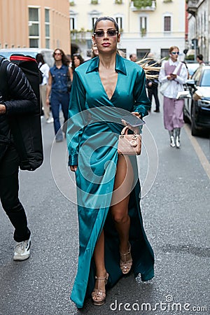 Woman with blue silk dress and Dior bag before Alberta Ferretti fashion show, Milan Fashion Editorial Stock Photo