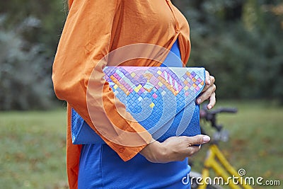 Woman orange shirt and blue and colorful bag before Sportmax fashion show, Milan Fashion Week Editorial Stock Photo