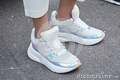 Woman with white and iridescent sneakers before Luisa Beccaria fashion show, Milan Fashion Week Editorial Stock Photo