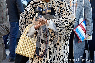 Woman with pearls bag, fur coat and professional Canon camera before Diesel Black Gold fashion show, Milan Editorial Stock Photo