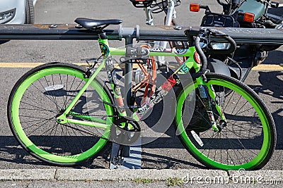 Single speed green bike with stickers seen before Pal Zileri fashion show, Milan Fashion Week street style on Editorial Stock Photo