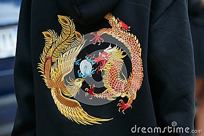 Woman with jacket with dragon and peacock design in gold before Fendi fashion show, Milan Fashion Week Editorial Stock Photo