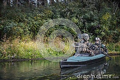 Militants in army kayak Stock Photo